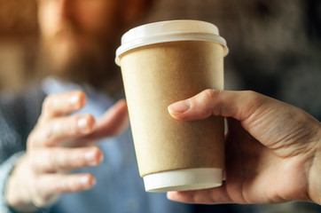 Barista serves coffee to a man. Hand Paper cup Break Beard Blazer. Coffee Break Concept
