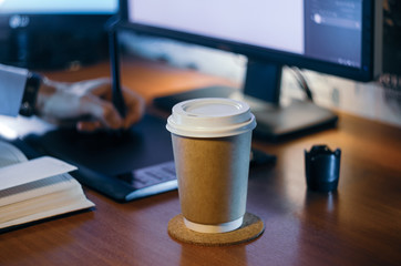 Desktop side view. Computer Graphics Tablet Diary Cup of coffee Hand. Concept for website banner, mockup, background, presentation and marketing material