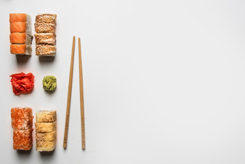 set of delicious sushi with ginger and wasabi on a white background, space for text