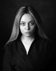 Dramatic black and white portrait of a beautiful woman on a dark background