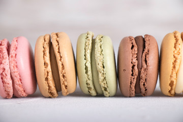 Colorful pastel macarons on gray background