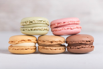 Colorful pastel macarons on gray background