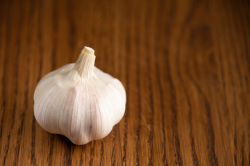 Garlic bulb on the wooden vintage background