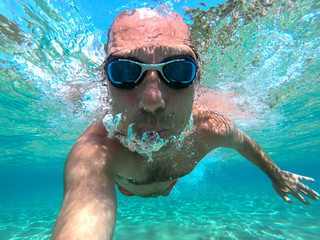 Underwater selfie shot of a swimmer in the sea