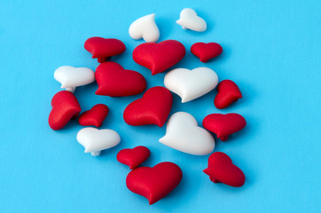 A few of red and white little hearts against blue background