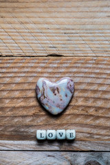 Lettres Love et coeur en jaspe sur un fond bois