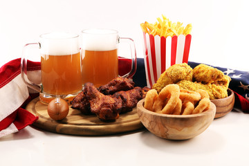 chicken wings, fries and onion rings for football on a table. Great for Bowl Game