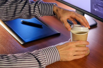 Desktop side view. Computer Graphics Tablet Cup of coffee Hand. Concept for website banner, mockup,...