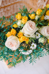 a large balloon with a basket decorated with live fresh flowers, as a festive props for a children's holiday birthday of yellow. close-up, details