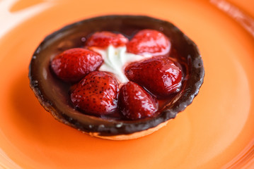 Cake with strawberries and ice cream photographed close-up.