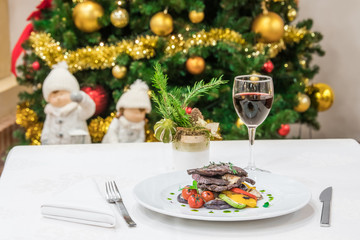 Christmas dinner next to a Christmas tree