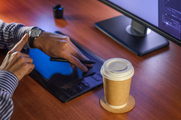 Desktop side view. Computer Graphics Tablet Clock Cup of coffee Hand. Concept for website banner, mockup, background, presentation and marketing material