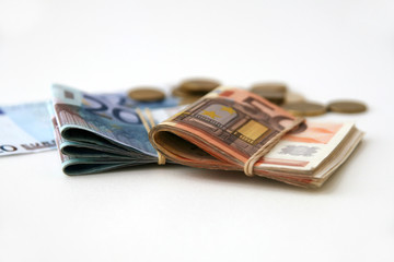 Euro banknotes and coins isolated on white