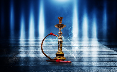 Hookah smoking on a blue futuristic background of an empty room, neon light, smoke