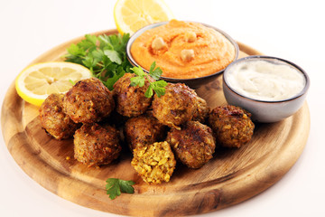 Traditional homemade hummus, falafel and chickpea served with spices on table. Jewish Cuisine.