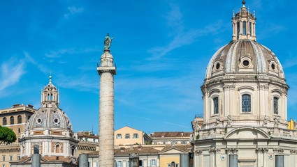 Fototapeta na wymiar panoramic view on Trajan's Column in front of catholic church Chiesa del Santissimo Nome di Maria al Foro Traiano in Rome, Italy