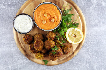 Traditional homemade hummus, falafel and chickpea served with spices on table. Jewish Cuisine.