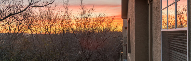 Panorama view typical park side apartment complex during winter sunrise with dramatic cloud reflection on windows. Aerial view of apartment building in Texas, America