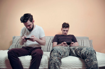 Anti social behavior , young adult male and teen staring in smartphone 