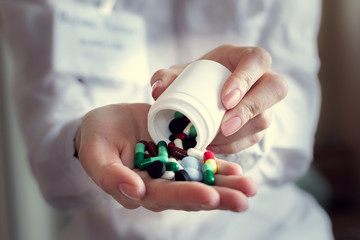 colorful pills capsules in a doctor's hand