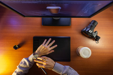 Desktop top view. Computer Graphics Tablet Camera Cup of coffee Hand Flat lay. Concept for website...