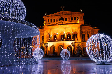 Alte Oper (Old Opera), a concert hall and former opera house in Frankfurt am Main, Germany, with Christmas decorated fountain during winter evening