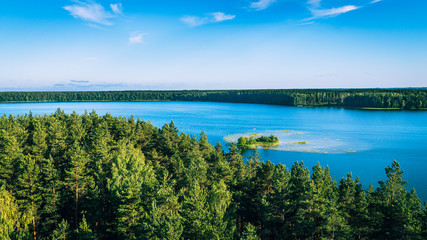Vivid blue lake and green forests with an island
