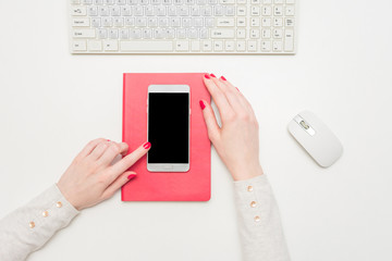 Woman uses a smart phone, copy space, top view, advertising