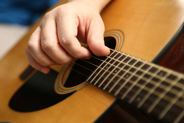 Fototapeta premium Playing guitar. The hands of a guitarist closeup and classic six-string guitar.