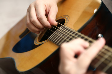 Playing guitar. The hands of a guitarist closeup and classic six-string guitar.