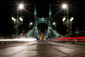 Fototapeta na wymiar A picture of the Liberty bridge in Budapest, Hungary at night with the light traces from the cars. 