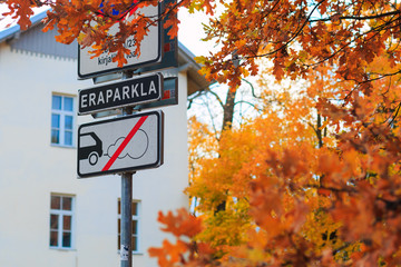 Traffic sign and sign "private parking" (black one) in historical city center of Tartu, Estonia