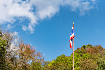 Thai flag blowing in the wind Trees around the sky and clouds