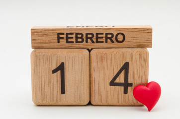 Calendar of rollover cubes with the date of February 14 and a little red heart against white background