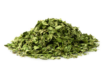A pile of dried chopped coriander leaves isolated on white.