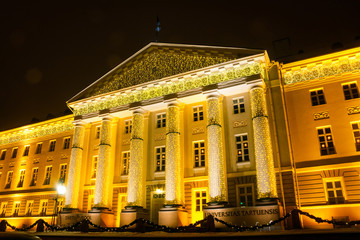 Facade of the main building of the University of Tartu, Estonia, in the Christmas decor on a winter evening