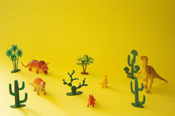 toys dinosaurs on a yellow background © Hanna
