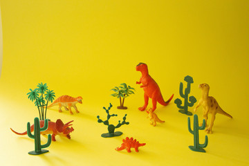 toys dinosaurs on a yellow background © Hanna