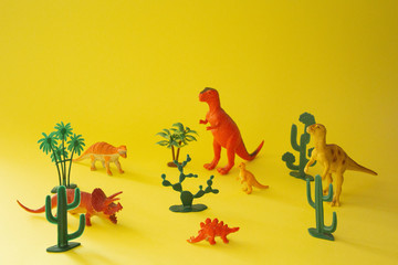 toys dinosaurs on a yellow background