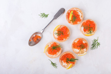 Tartlets with red caviar on white background. Top view