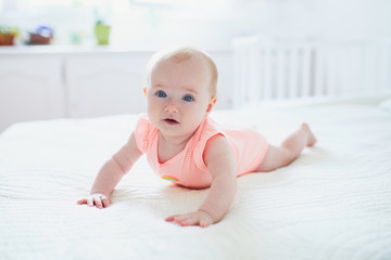 Cute baby girl lying on her tummy