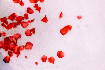 Bath water with rose petals. St. Valentine's Day bath. Aromatherapy with flower petals.