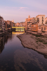 Girona's skyline famous landmark river view at the sunset. Onyar river and Cathedral skyline cityscape in famous city in Catalonia