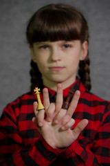 Obraz premium Girl holding chess pieces in front of her. Black and white chess king in the hands of a girl