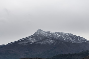 Snowy mountain peak landscape on a cloudscape sky