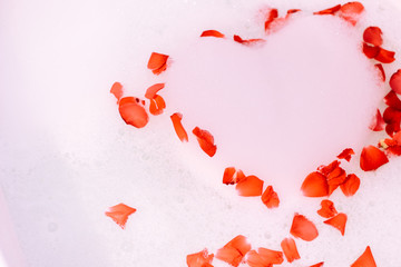 Romantic bath with rose. St. Valentine's Day bath. Aromatherapy with flower petals.