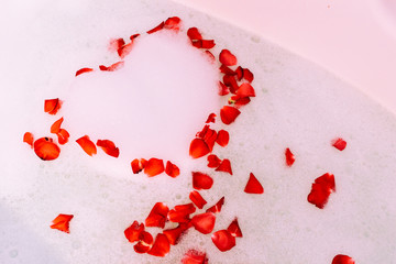 Bath water with rose petals. St. Valentine's Day bath. Aromatherapy with flower petals.