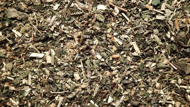 Green dried mix herbs background. Top view. Alternative herbal medicine