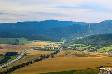 Fototapeta na wymiar Landscape on fields with wheat against the background of mountains. Slovakia