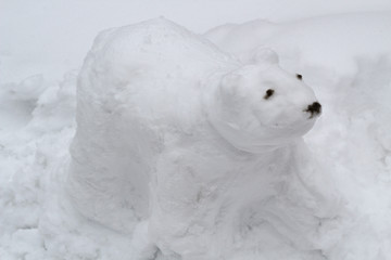 The figure of the white bear cobbled together out of the snow children. Bear-snowman